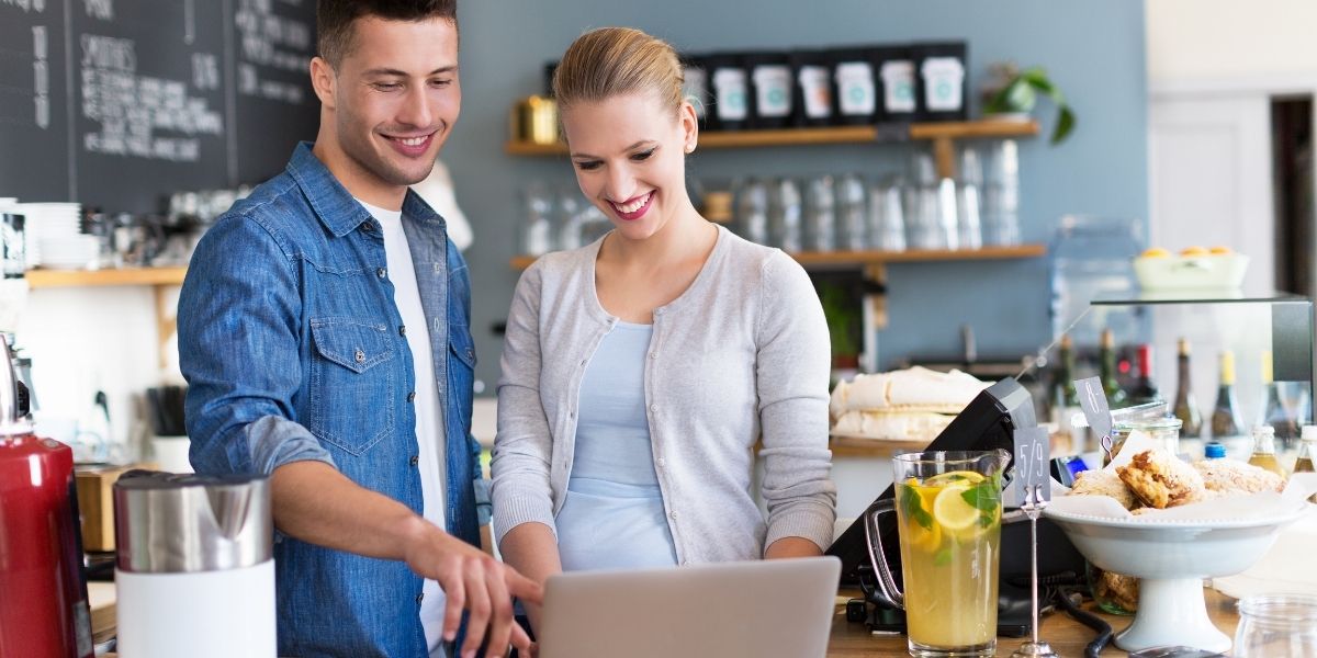 pos-dealer-in-wethersfield-ct-showing-a-merchant-how-to-use-total-touch