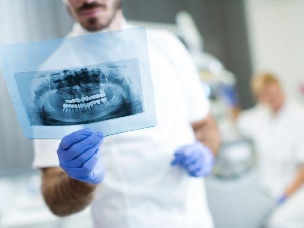 dentist looking at an x-ray