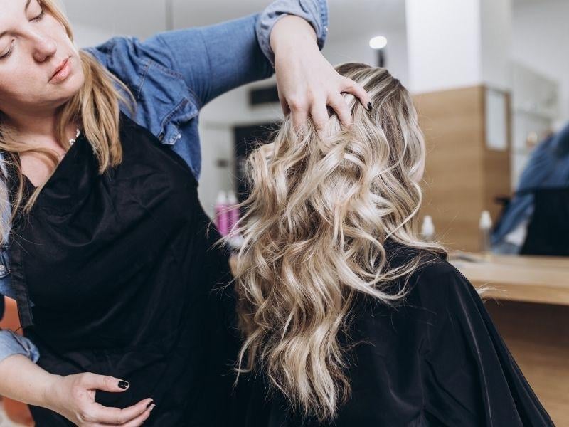 a customer getting highlights at a salon