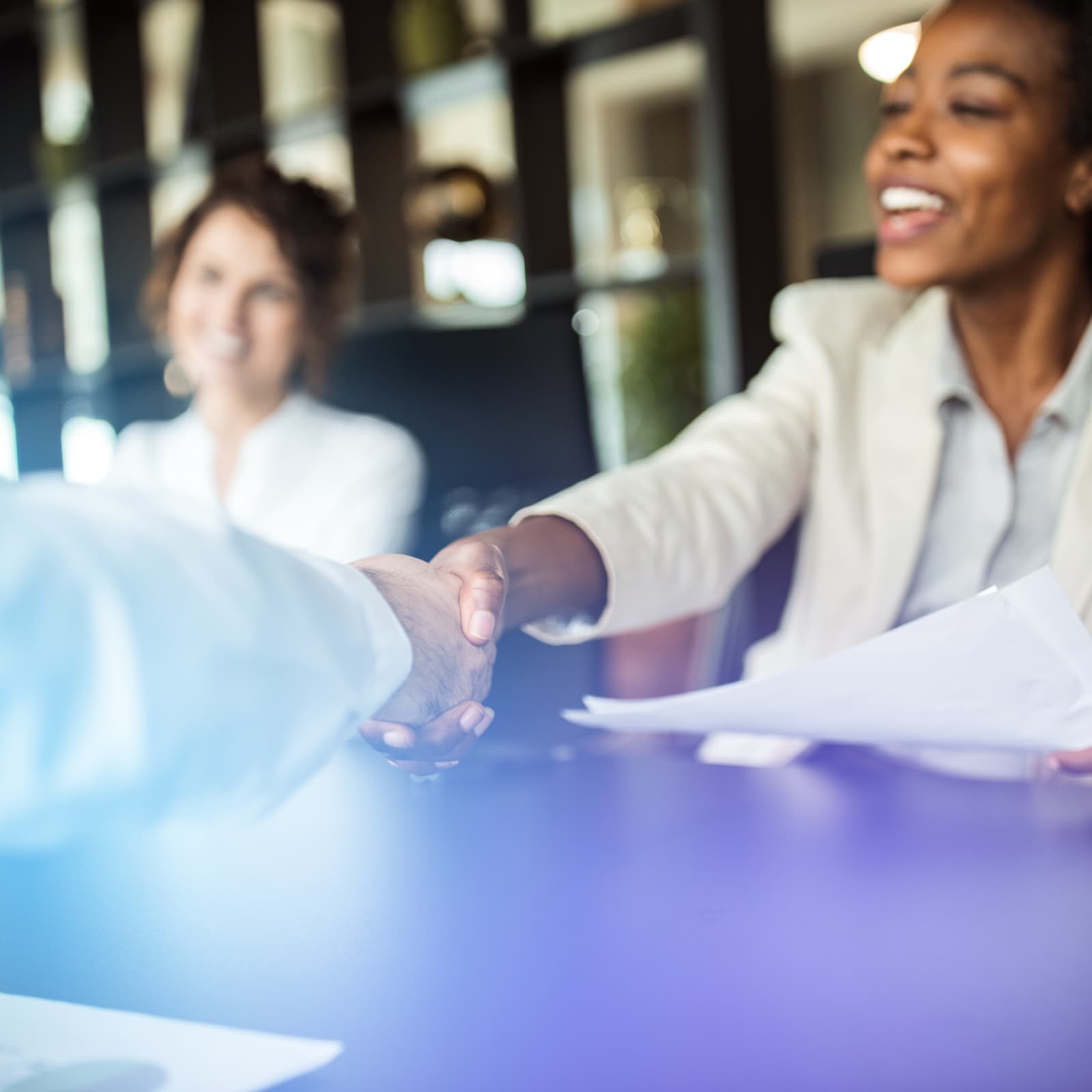 Female lawyer shaking hands across table