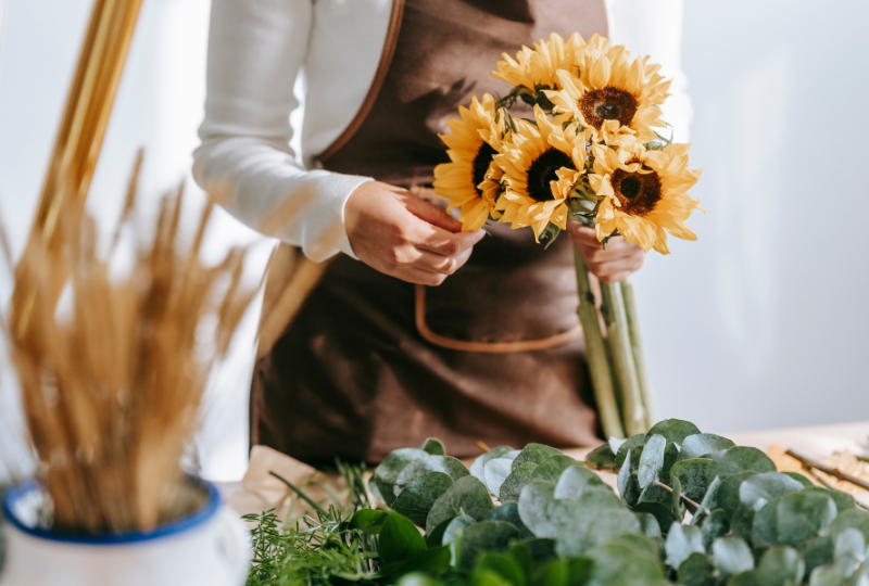 Customer pays florist with credit card for flower arrangement