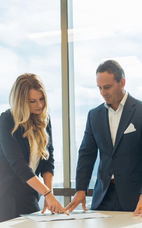 two-texas-merchant-services-agents-looking-over-a-deal