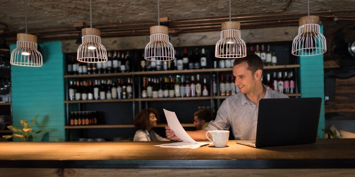 pos-reseller-looking-over-paperwork-in-his-clients-restaurant