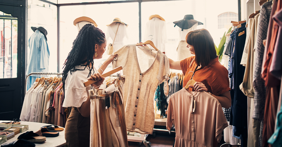 Two young women shopping at a clothing boutique