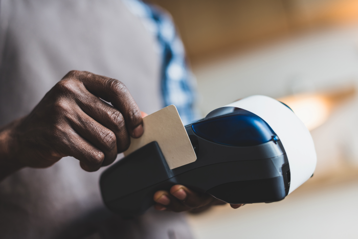 A customer swiping a credit card on one of the best mobile credit card readers. 