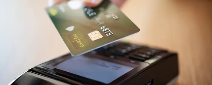 A credit card being tapped at a mobile terminal at a business using flat rate processing.